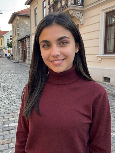 Amina, 26, Bosnian woman from Sarajevo wearing burgundy turtleneck on old town street