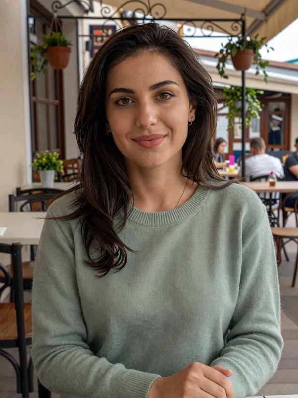 Macedonian woman in a green sweater at a traditional cafe in Skopje, representing Macedonian singles on our dating platform